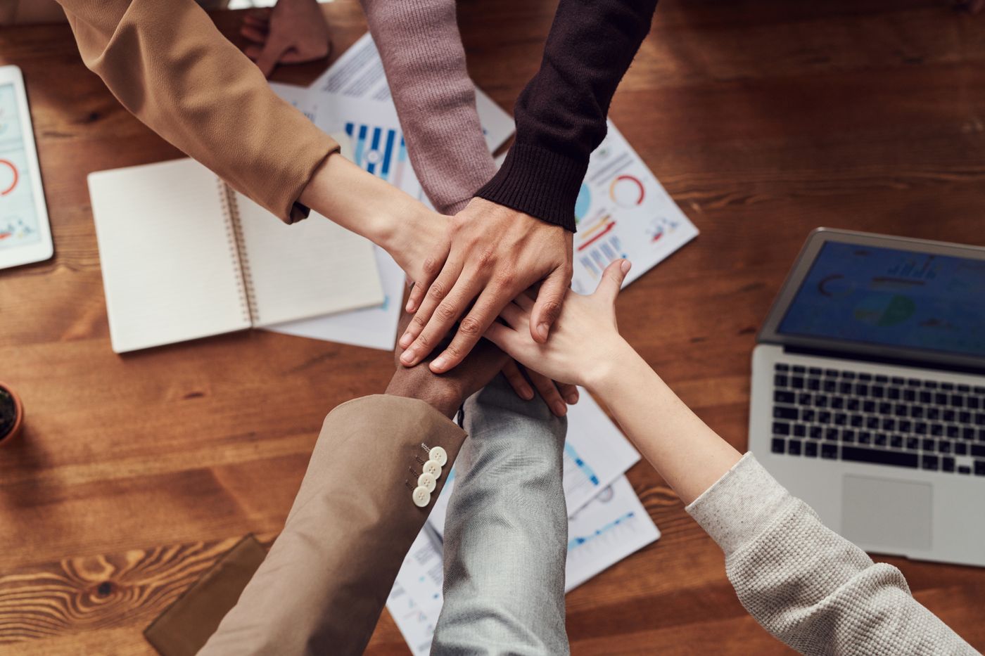 Small business team planning operations around a laptop